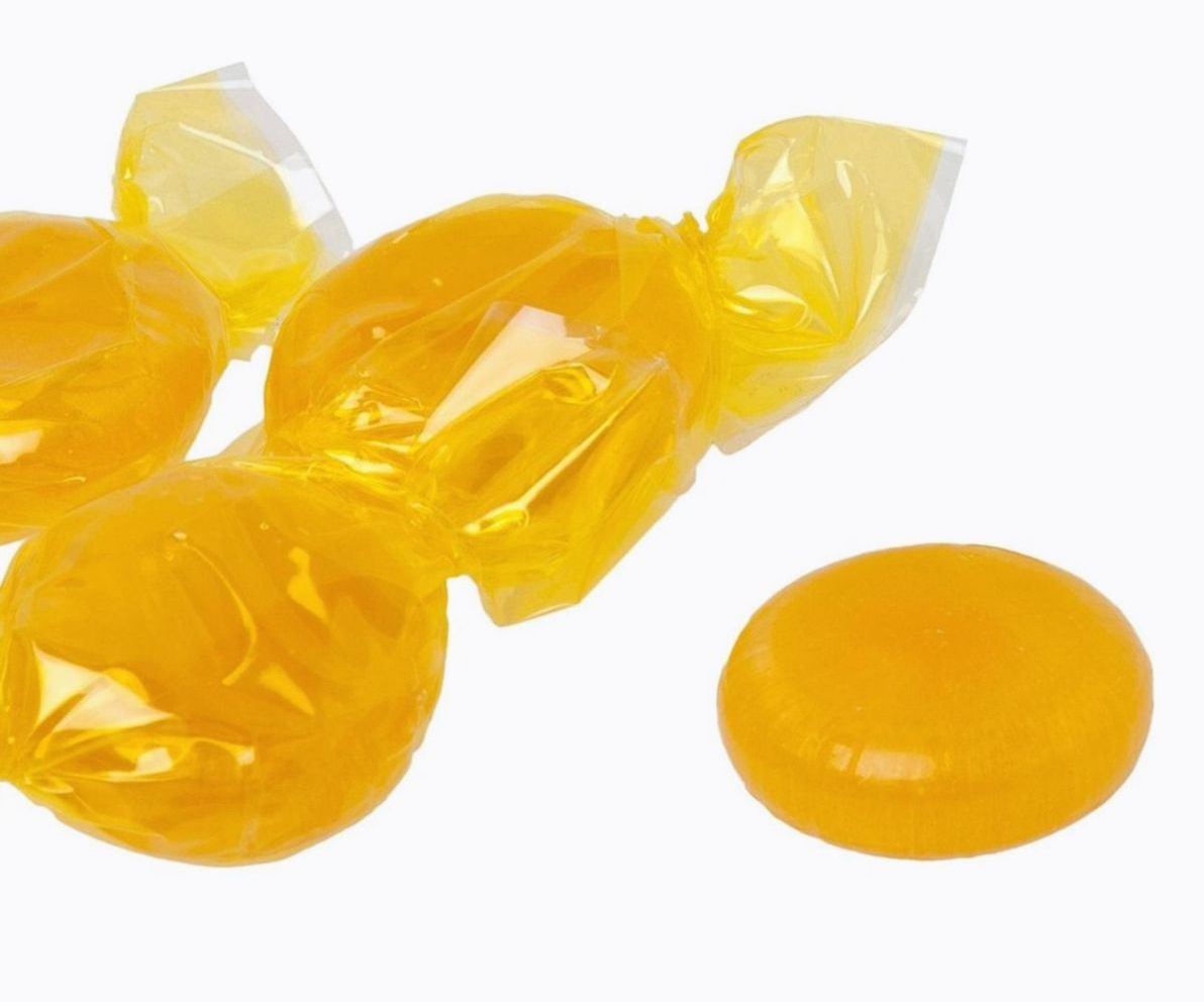 Artisan confectionery being hand-wrapped in gold foil